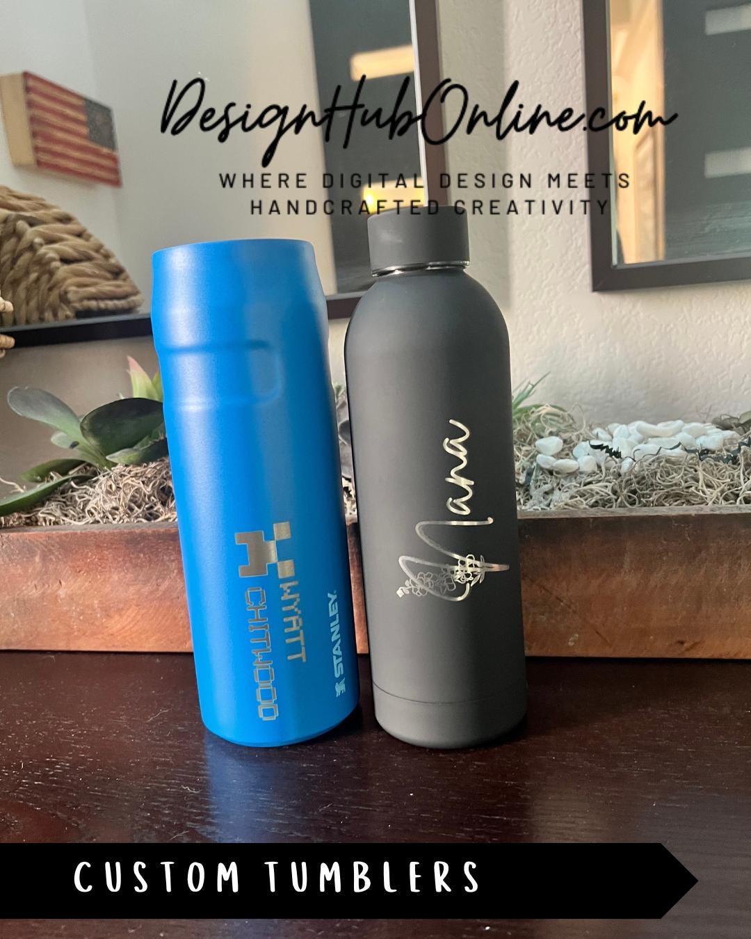Two custom tumblers, one blue and one gray, are displayed on a wooden surface.