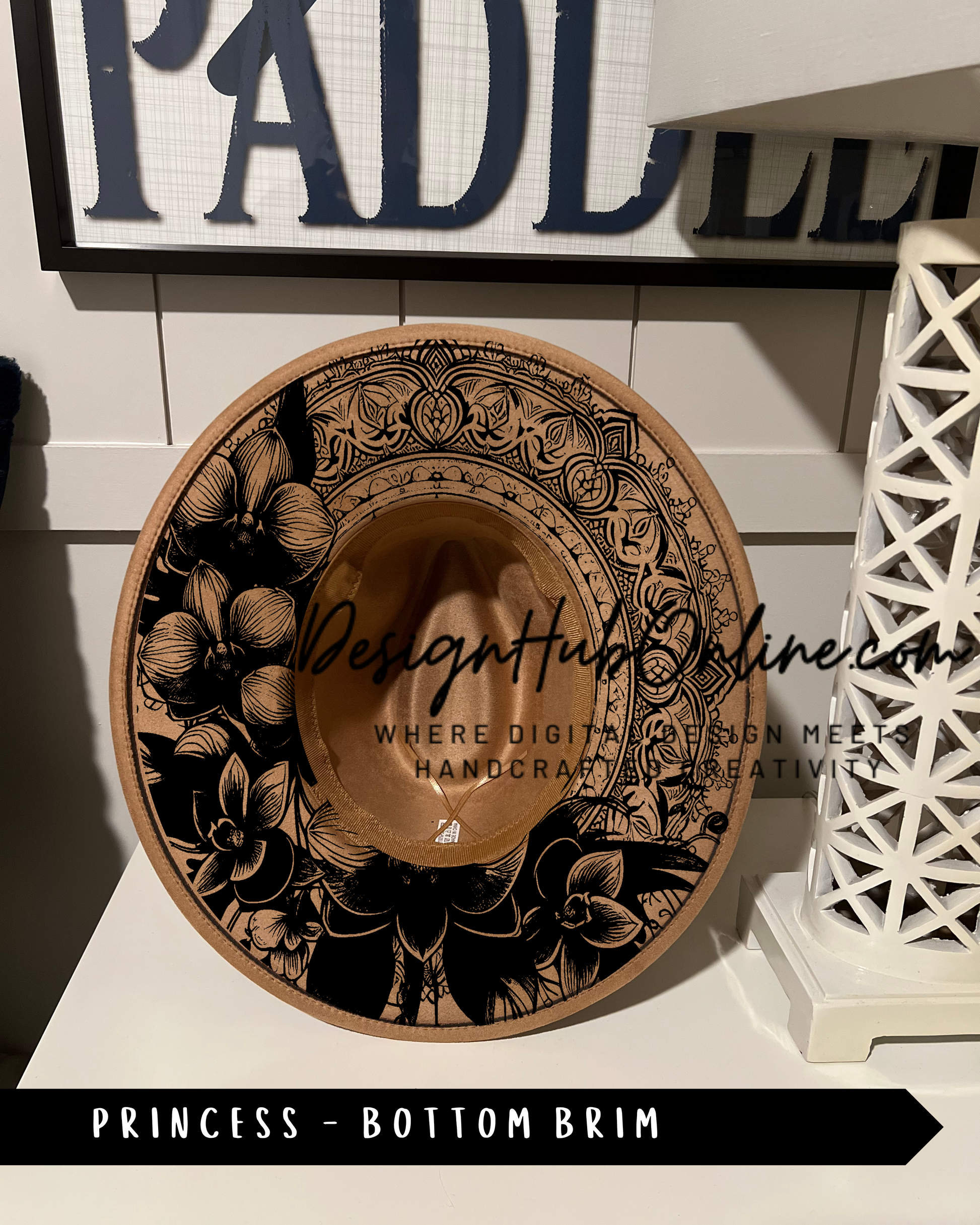 A decorative hat with floral patterns and a textured design, placed on a white surface.