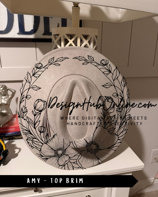 A white hat with a floral design on it, placed on a white dresser.