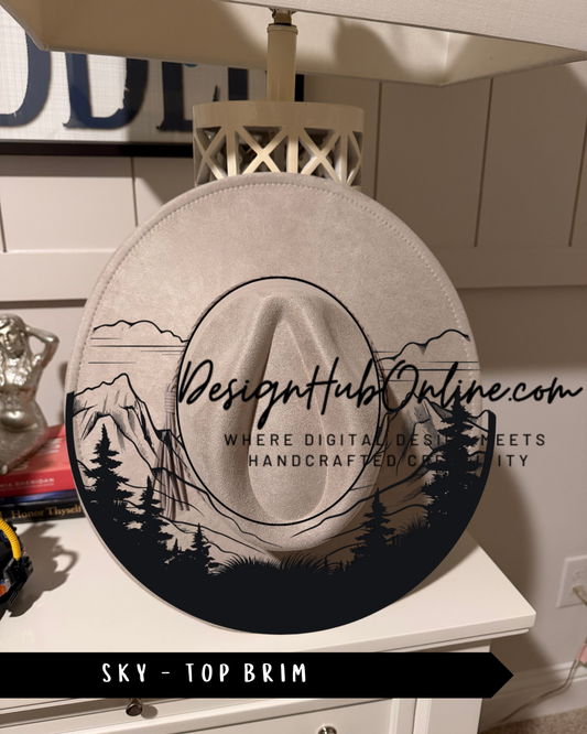A hat with a graphic design of a mountain landscape and trees, displayed on a white dresser.