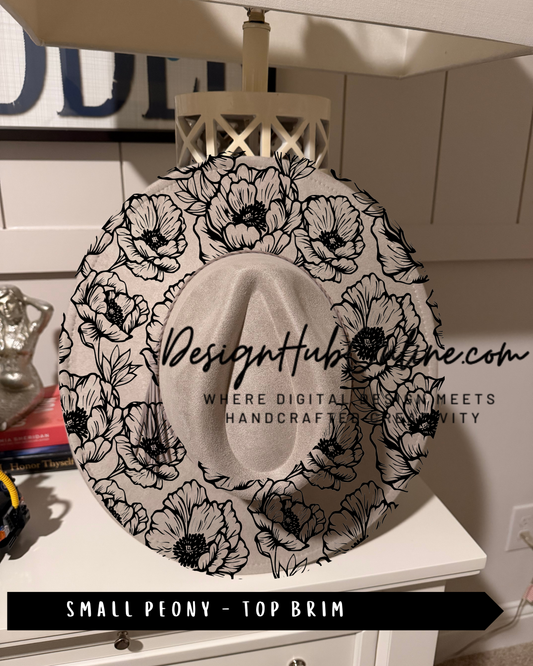 A black and white floral patterned hat with a white brim, displayed on a white dresser.