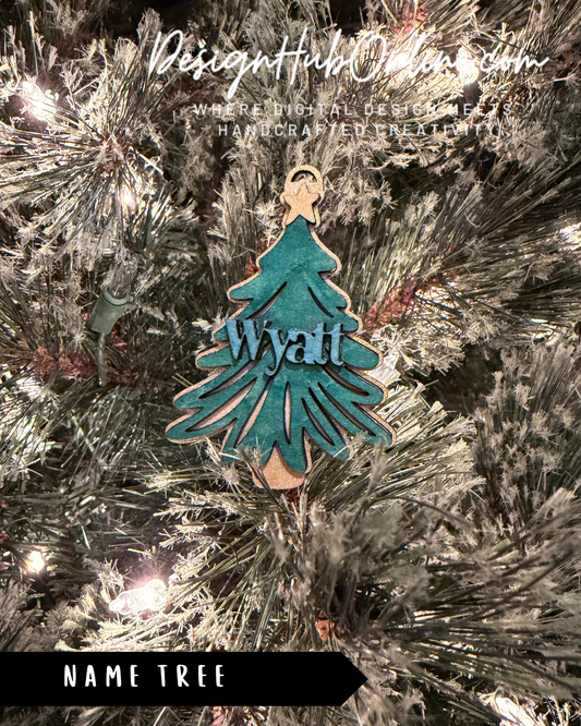 A Christmas tree decorated with a blue ornament that says "Wyatt" in the center.