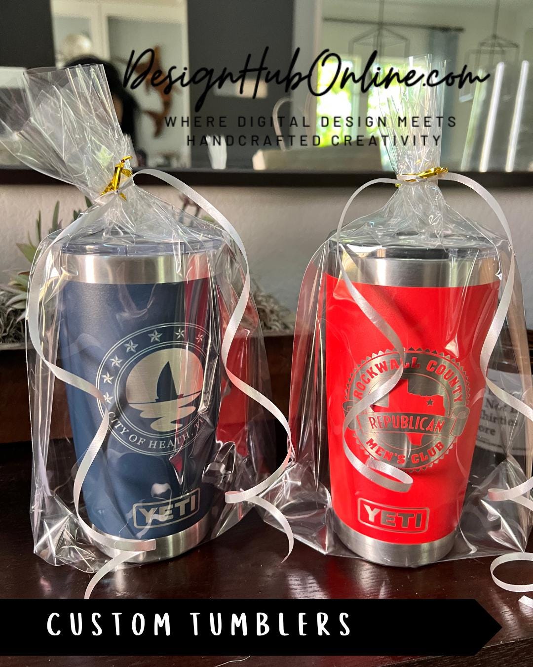 Two custom tumblers wrapped in clear plastic, one blue and one red, sitting on a table.