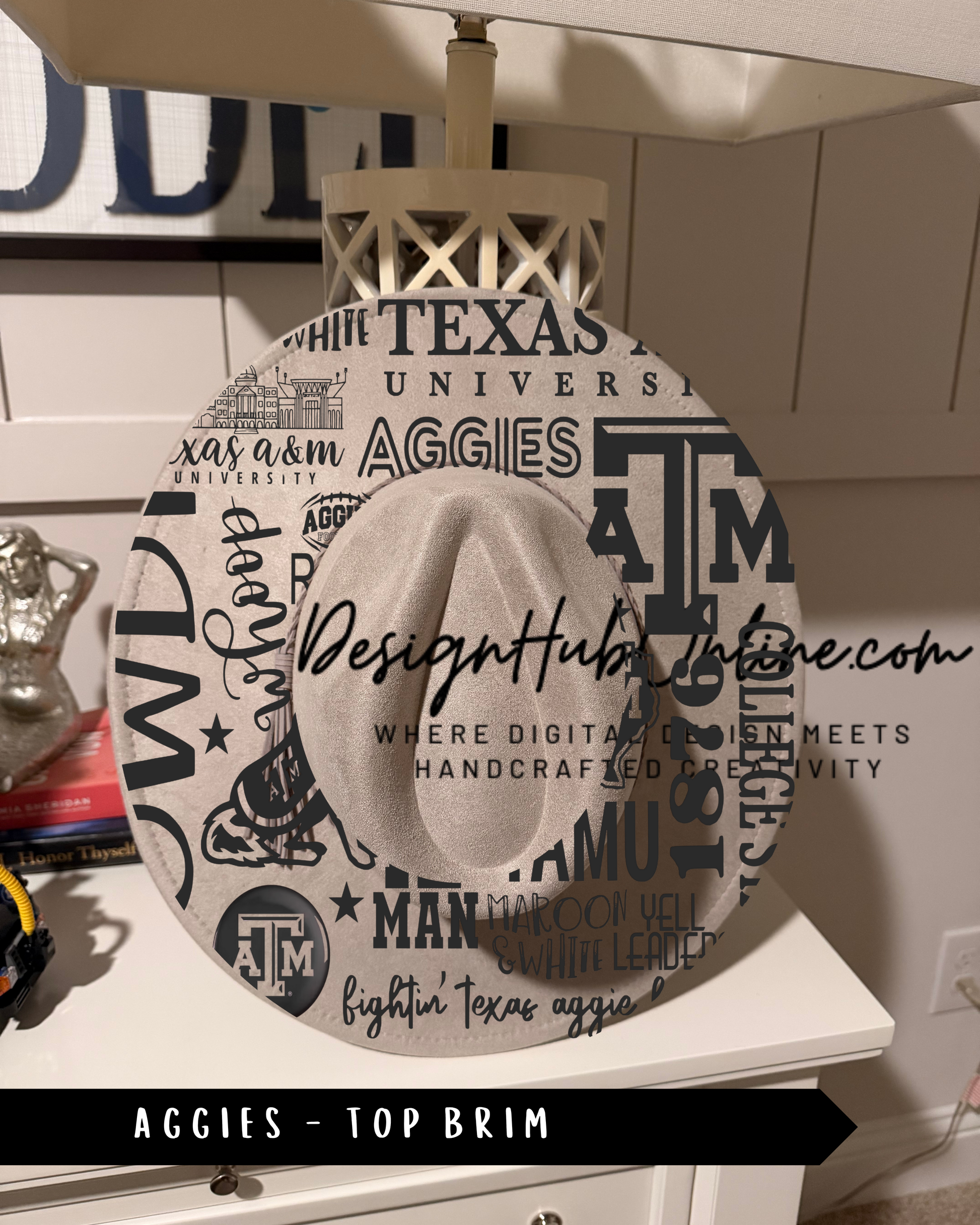 A hat with the words "Texas A&M University" printed on it, sitting on a white surface.
