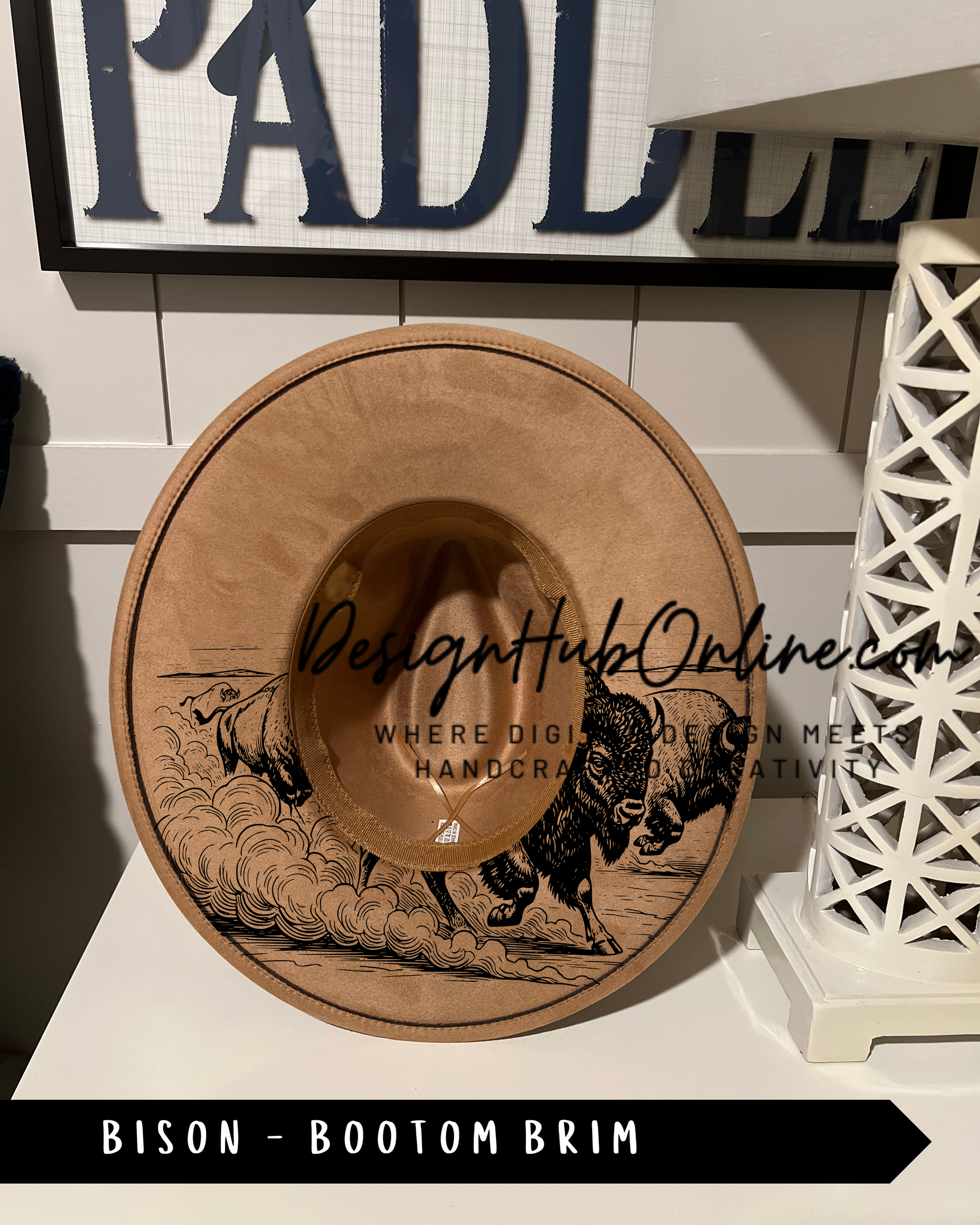 A wooden hat with a bison design on it, displayed on a shelf.