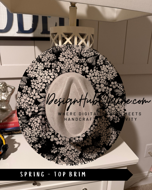A decorative black and white floral pattern on a hat, with the text "Design Hub" and "Spring - Top Brim" printed on it.