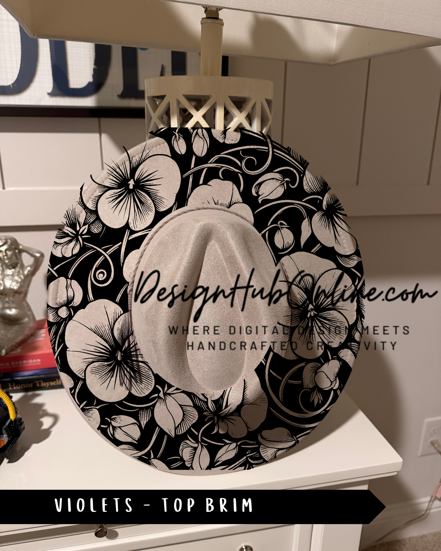 a decorative hat with a floral pattern, placed on a white dresser.