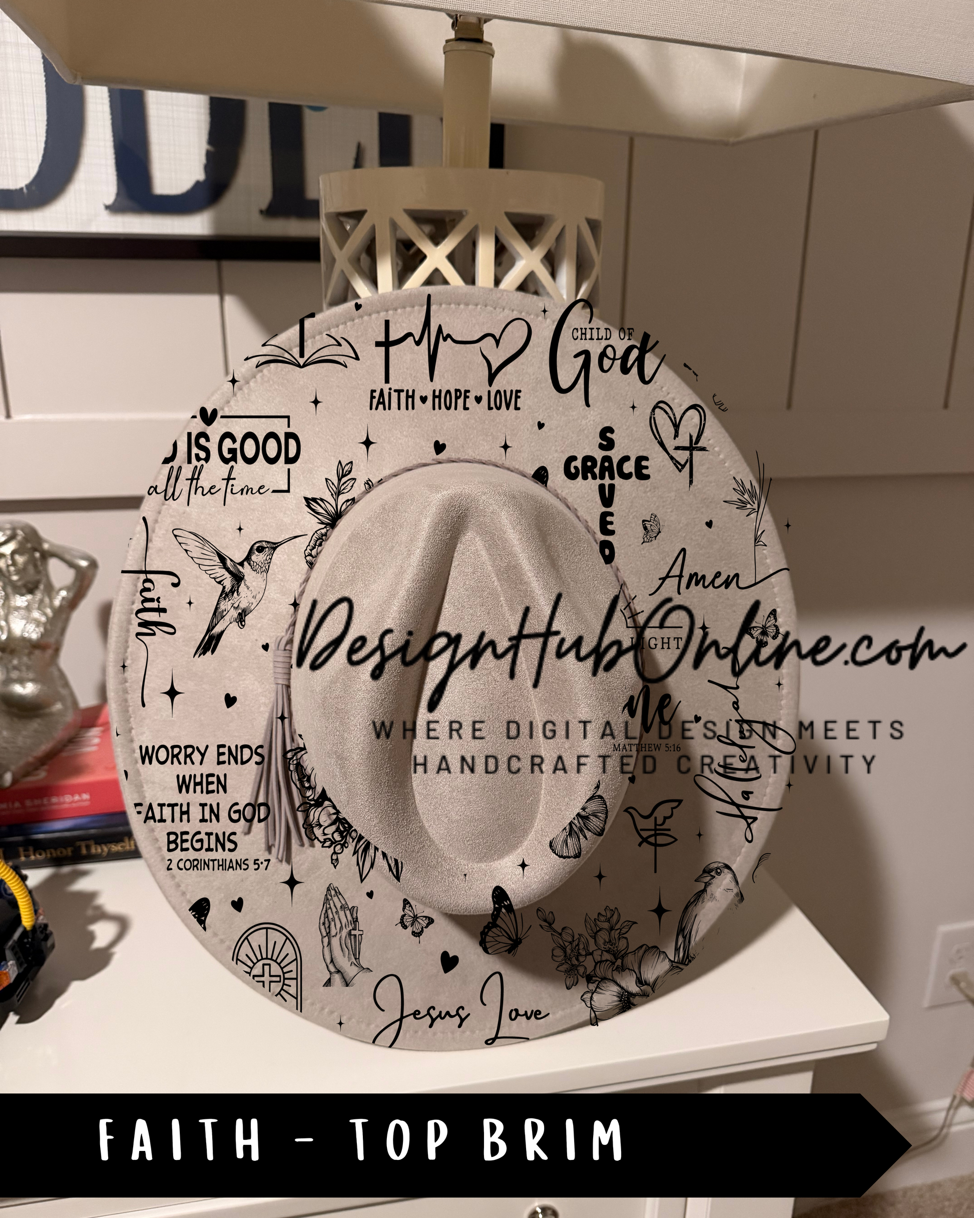 a hat with various religious and inspirational phrases and symbols printed on it, including words like "Faith", "Love", "Grace", and "Worry ends when God begins".