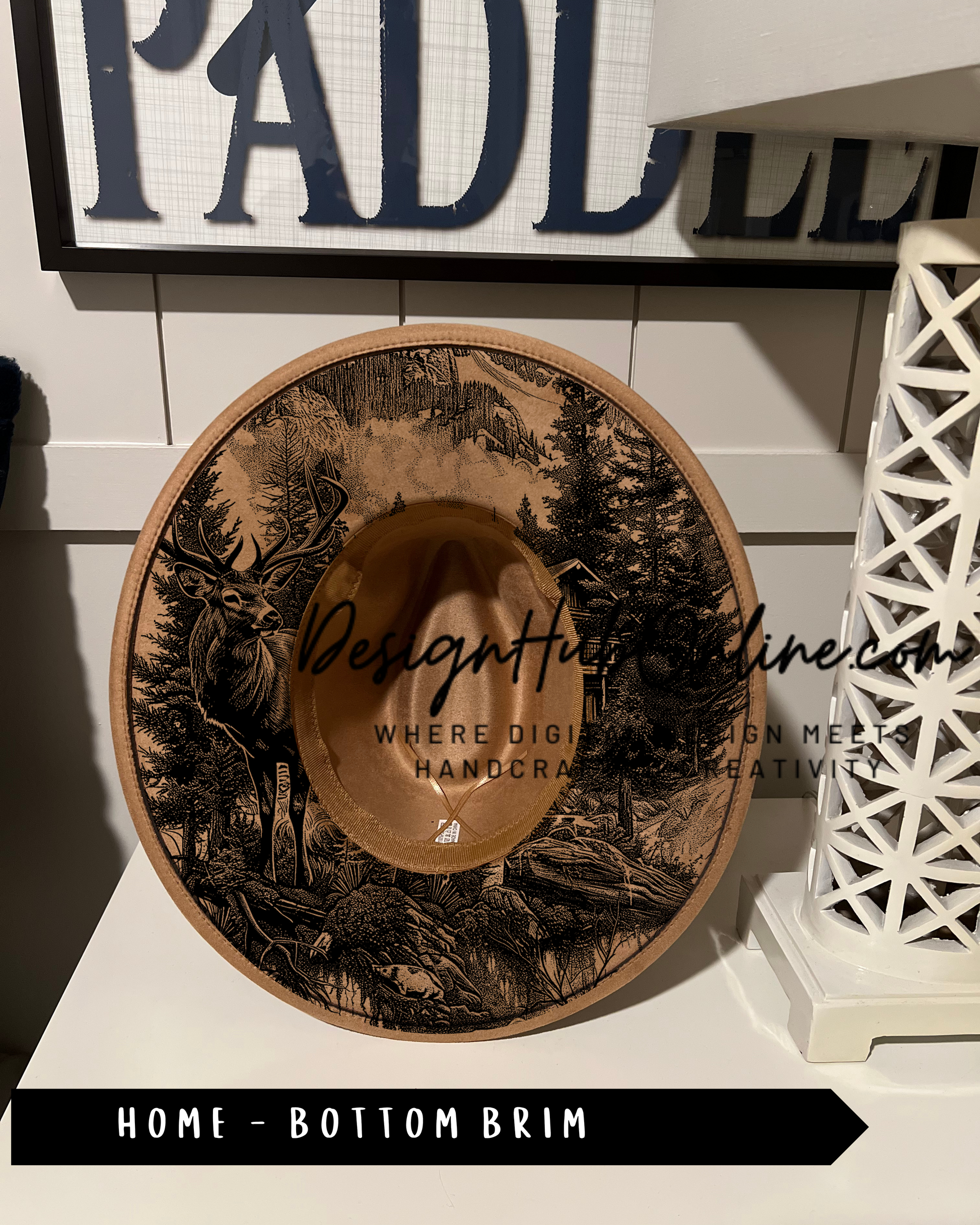 A decorative hat with a printed design of a deer and forest on the front, displayed on a shelf.