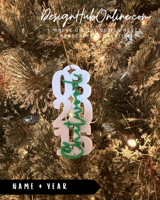 A close-up of a Christmas tree ornament with the text "Christmas" written on it, hanging from a tree.