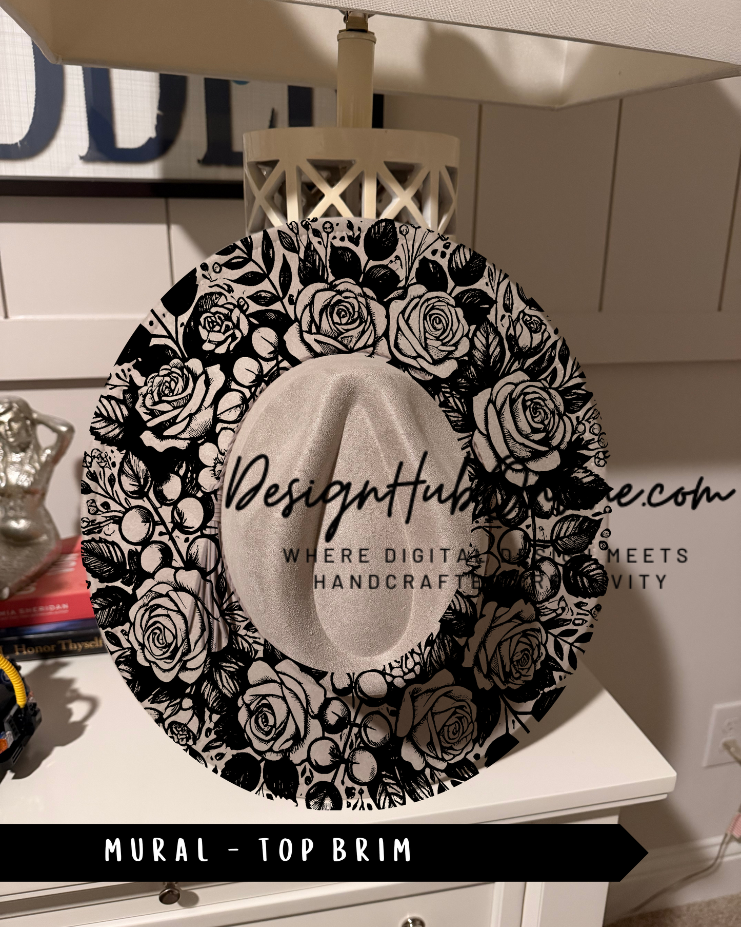 A decorative black and white floral pattern on a hat, with the text "Design Hub" and "Mural - Top Brim" printed on it.