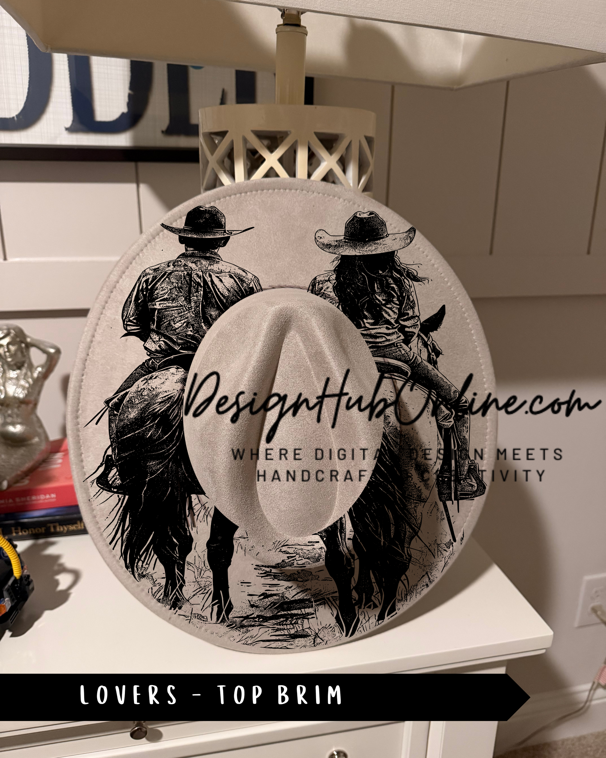 A hat with a graphic design featuring two people riding horses, with text that reads "Design Hub Online" and "Where digital design meets handicraft".