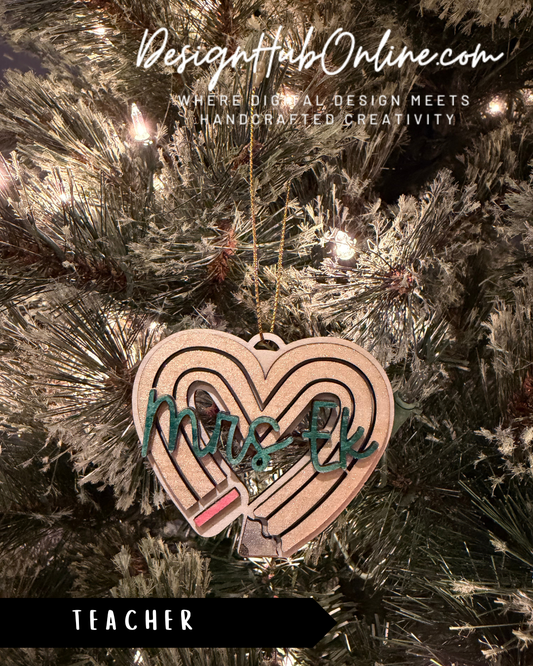 A heart-shaped ornament with the word "Mrs. EK" written on it, hanging from a Christmas tree.