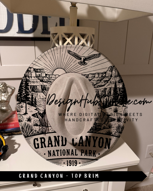 A decorative hat with a printed design of the Grand Canyon, featuring a sun, eagle, and mountains.