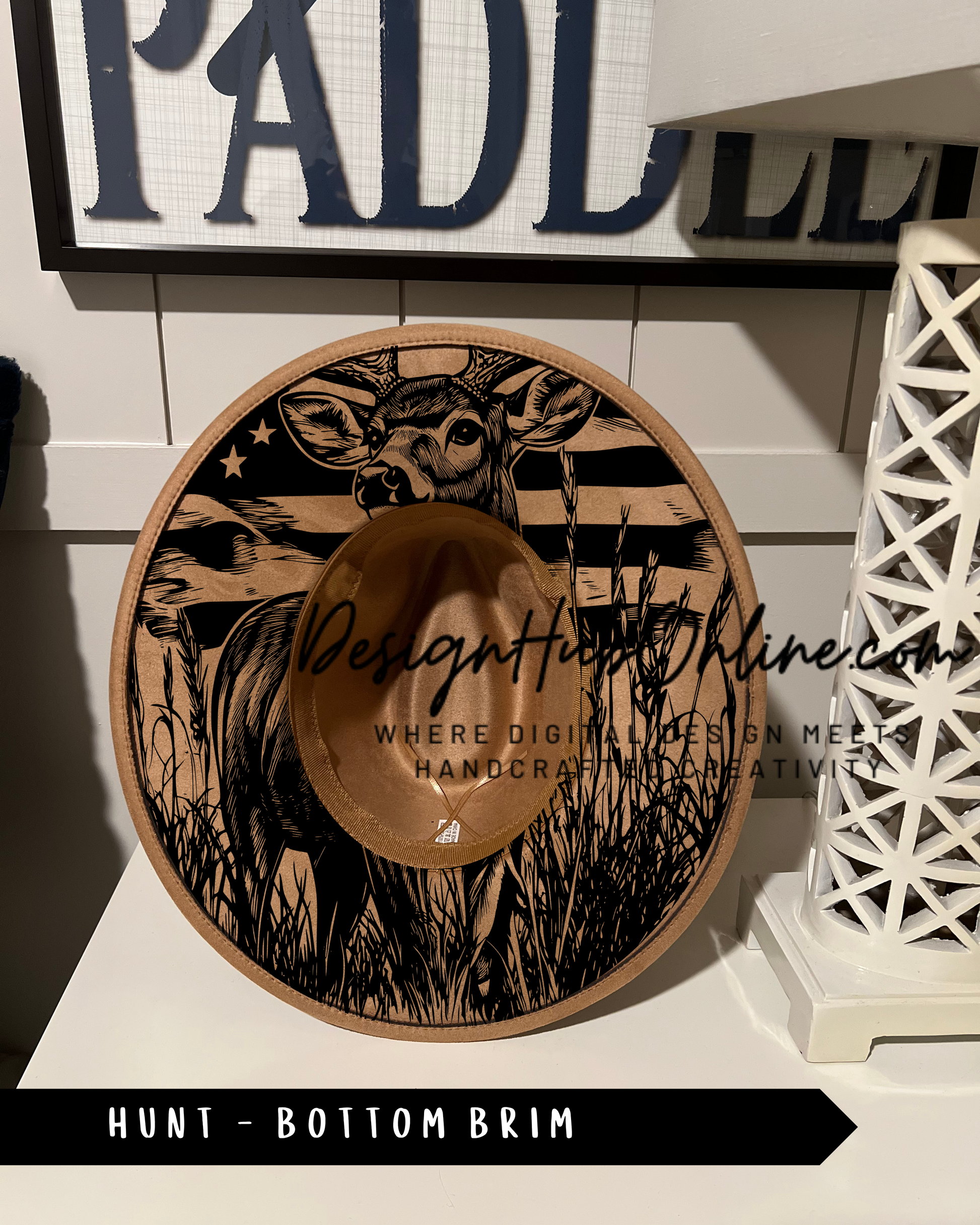 A hat with a deer design on it, placed on a shelf.