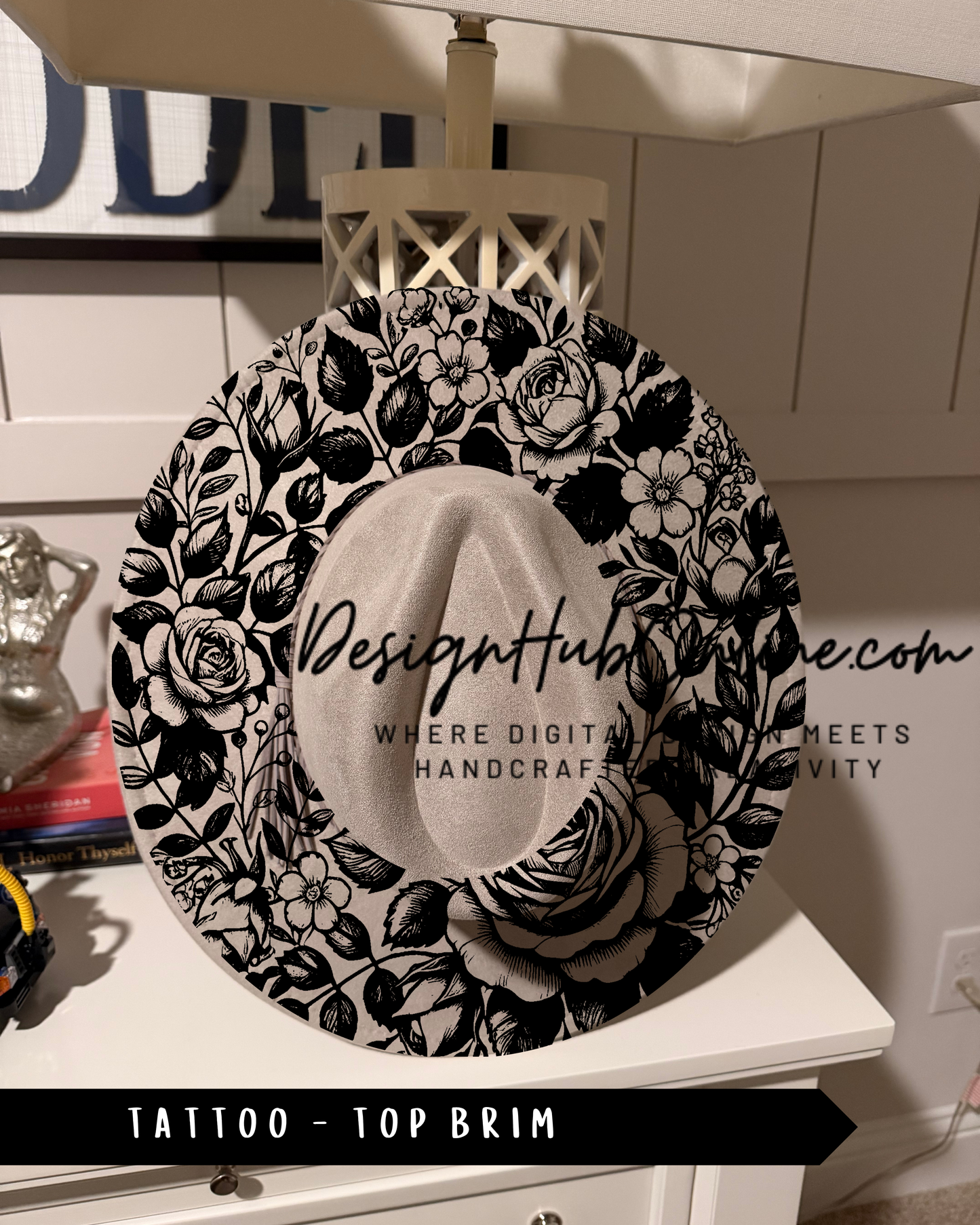 A decorative black and white floral pattern on a hat, with the text "Design Hub" and "TATTOO - TOP BRIM" printed on it.