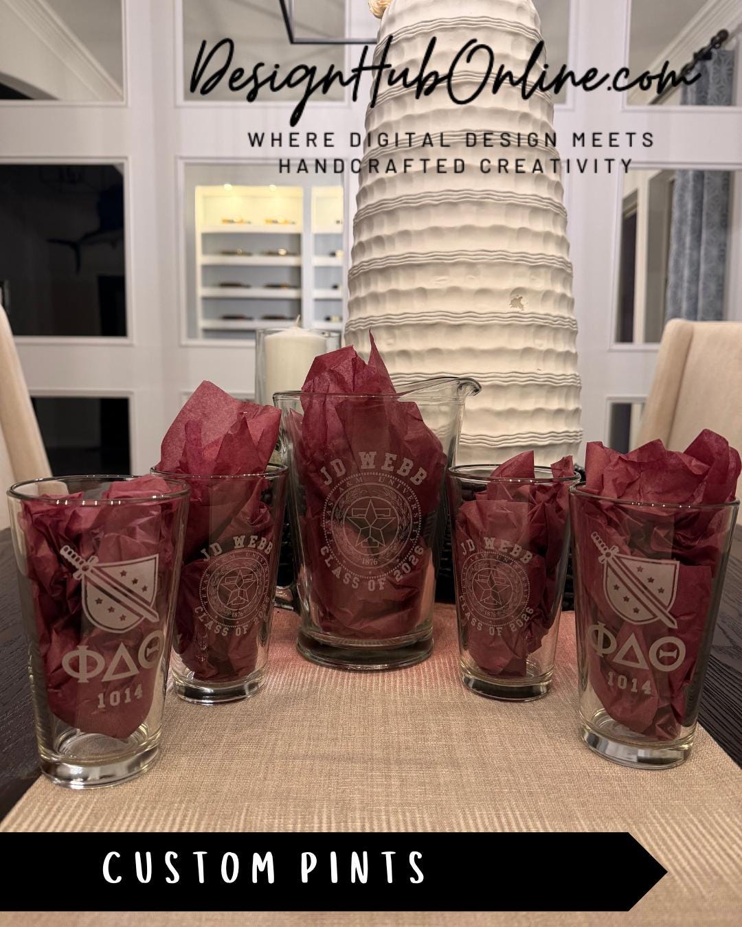 a set of custom pint glasses with engraved designs, placed on a table.