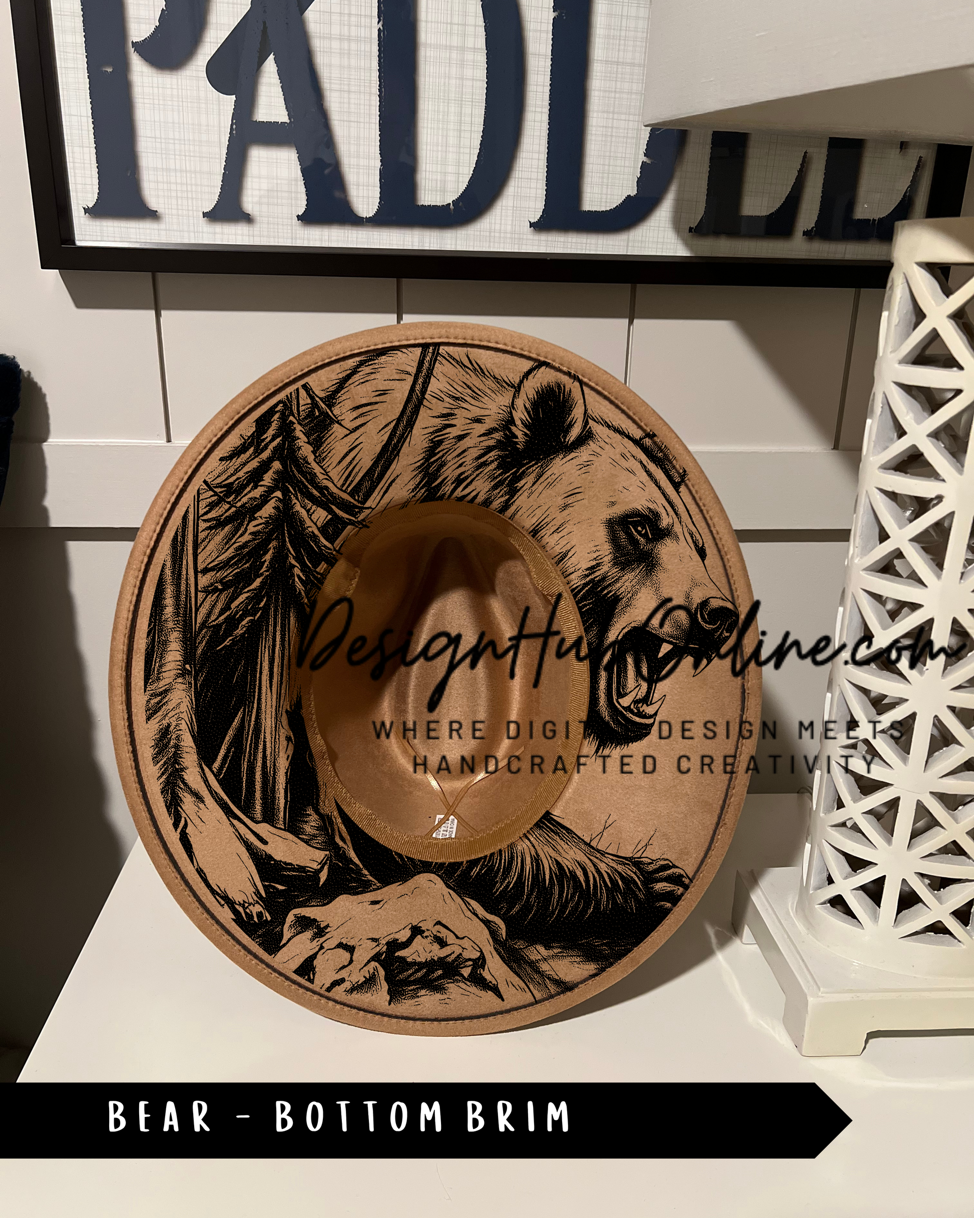 A wooden hat with a bear design on it, placed on a white surface.