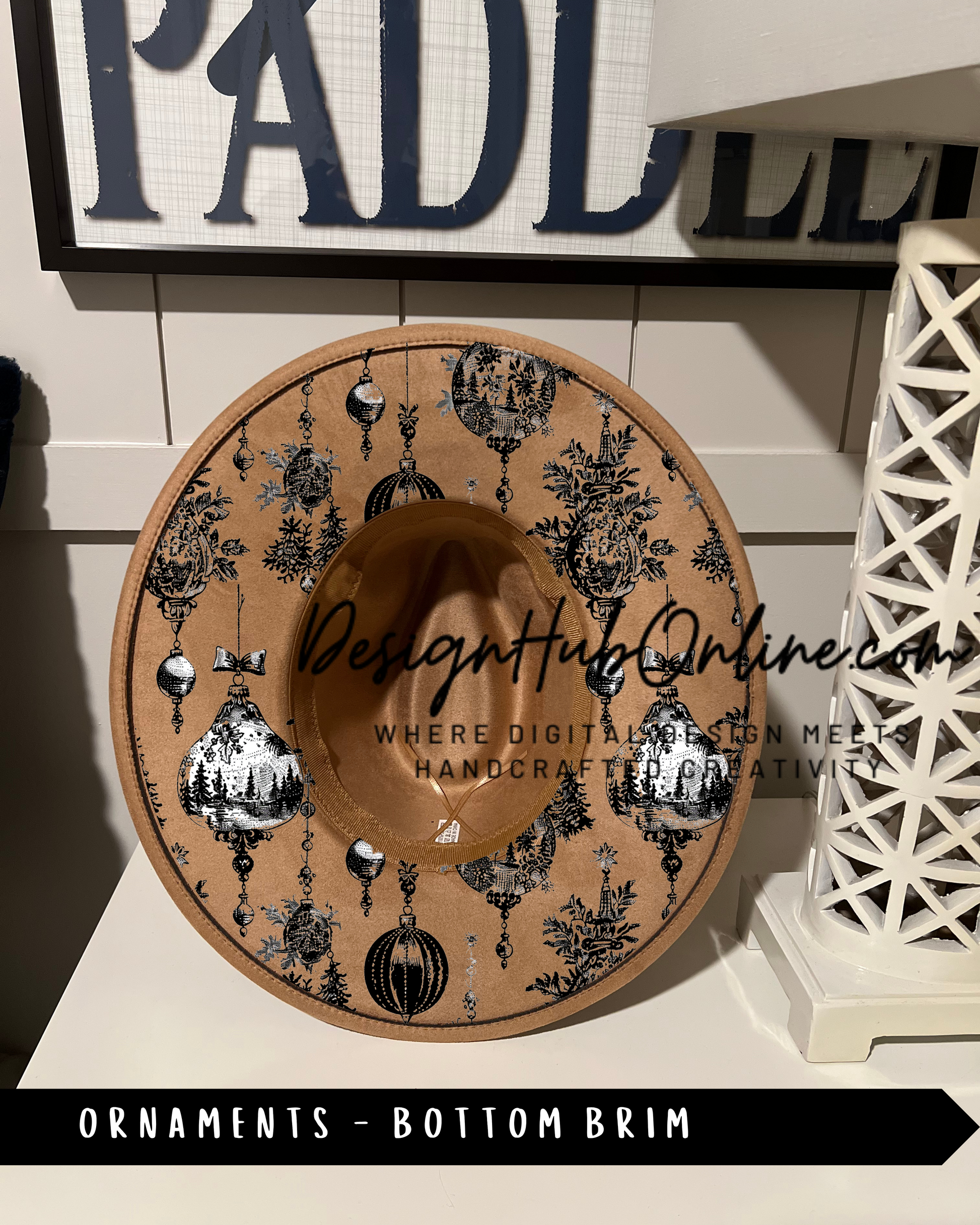 A decorative hat with a pattern of ornaments and a text overlay, placed on a shelf or table.